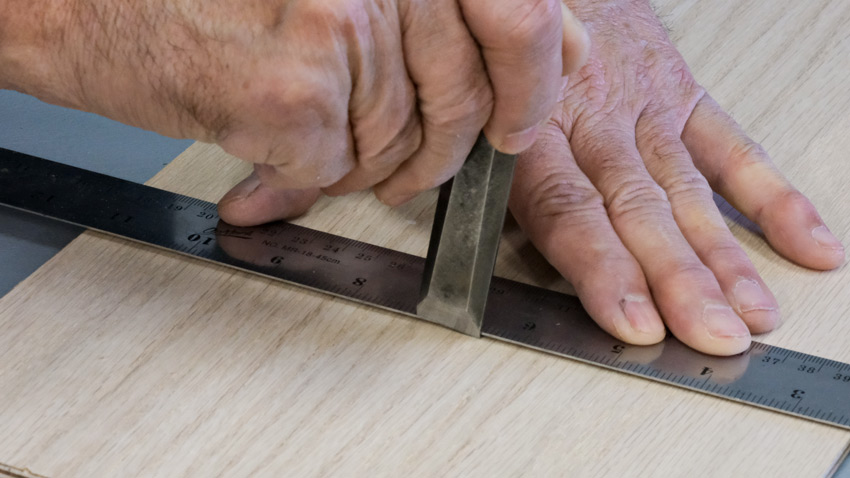 Using a chisel to mark wood